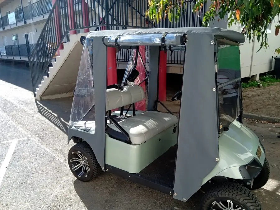 Golf cart cover fitted to a cart